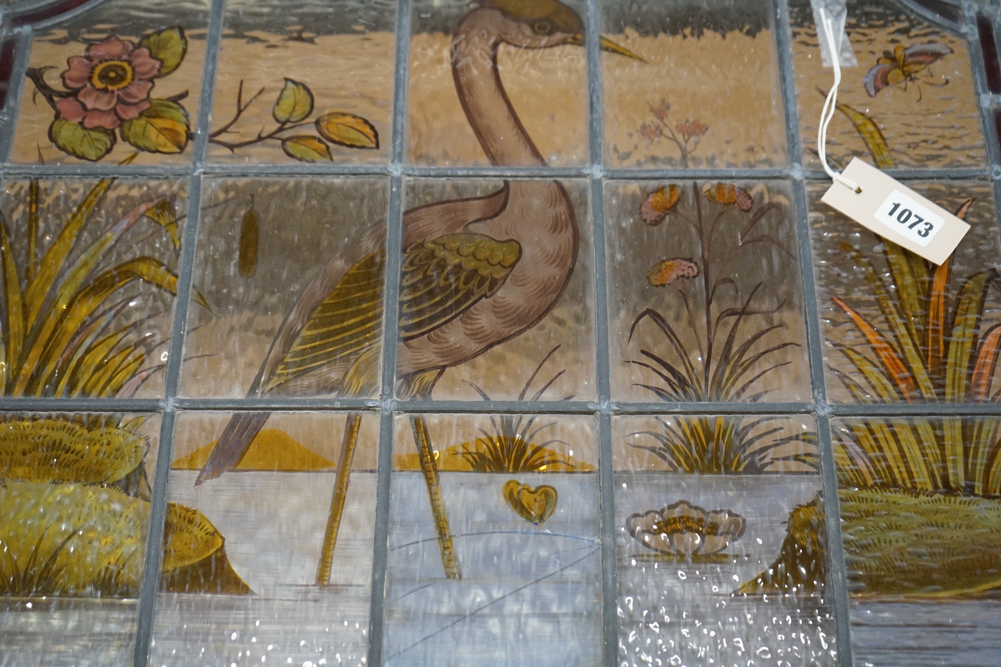 A late Victorian stained leaded glass panel depicting a heron amongst reeds, width 71cm, height 61cm